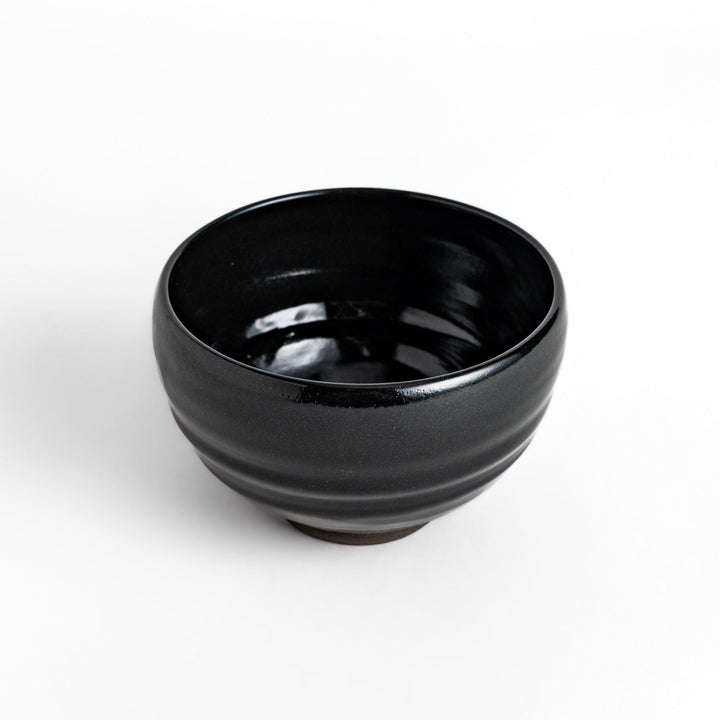 Elegant black ceramic Matcha bowl with a minimalist design, ideal for preparing and serving Matcha.