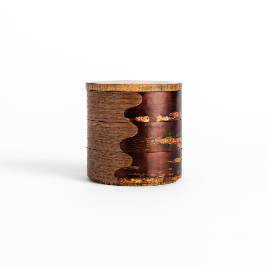 Exquisite jewelry case crafted from walnut and cherry bark, featuring a unique wavy design and a natural finish, perfect for storing precious treasures.