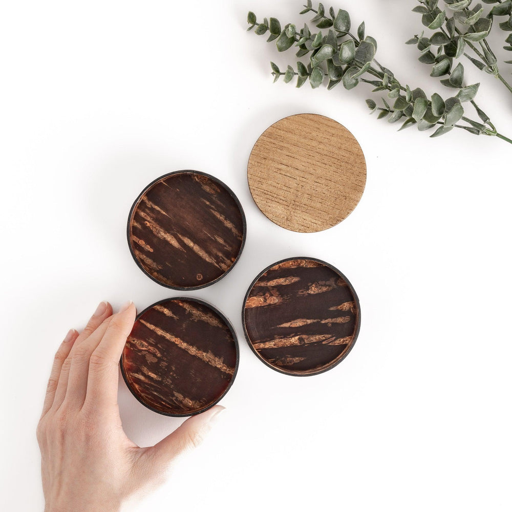 Hand opening a walnut and cherry bark jewelry case with three compartments, revealing a beautiful natural grain and ample storage space.