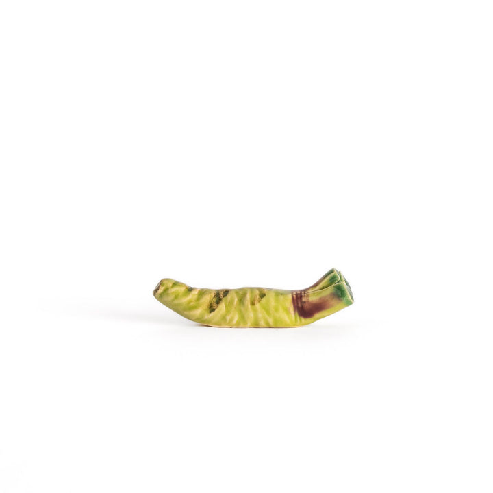 Ceramic wasabi chopstick rest in green tones, featuring intricate details that mimic the texture and shape of real wasabi roots.