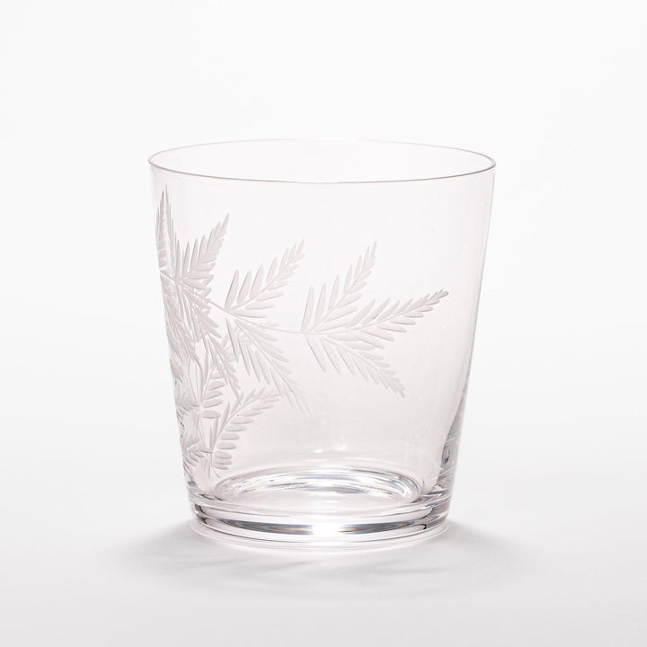 Elegant rocks glass with delicate fern engravings, offering a sophisticated design perfect for serving whiskey or other drinks.