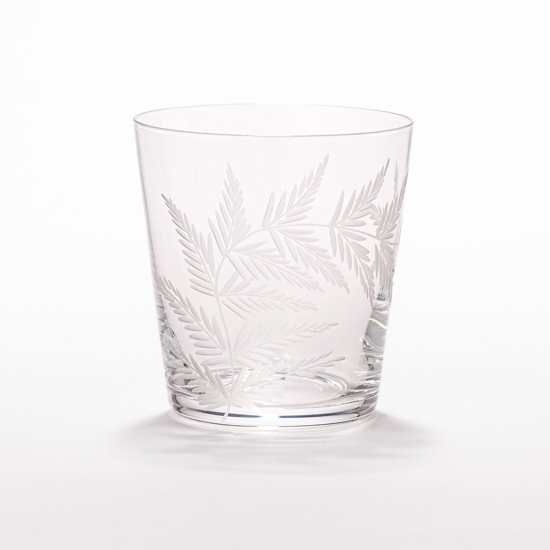 Elegant rocks glass with delicate fern engravings, offering a sophisticated design perfect for serving whiskey or other drinks.