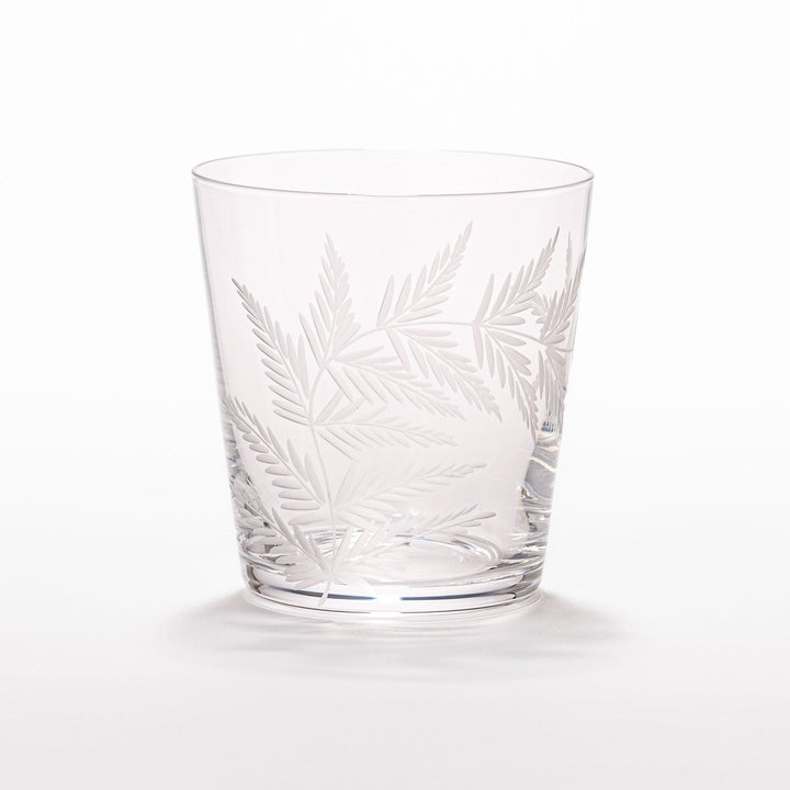 Elegant rocks glass with delicate fern engravings, offering a sophisticated design perfect for serving whiskey or other drinks.