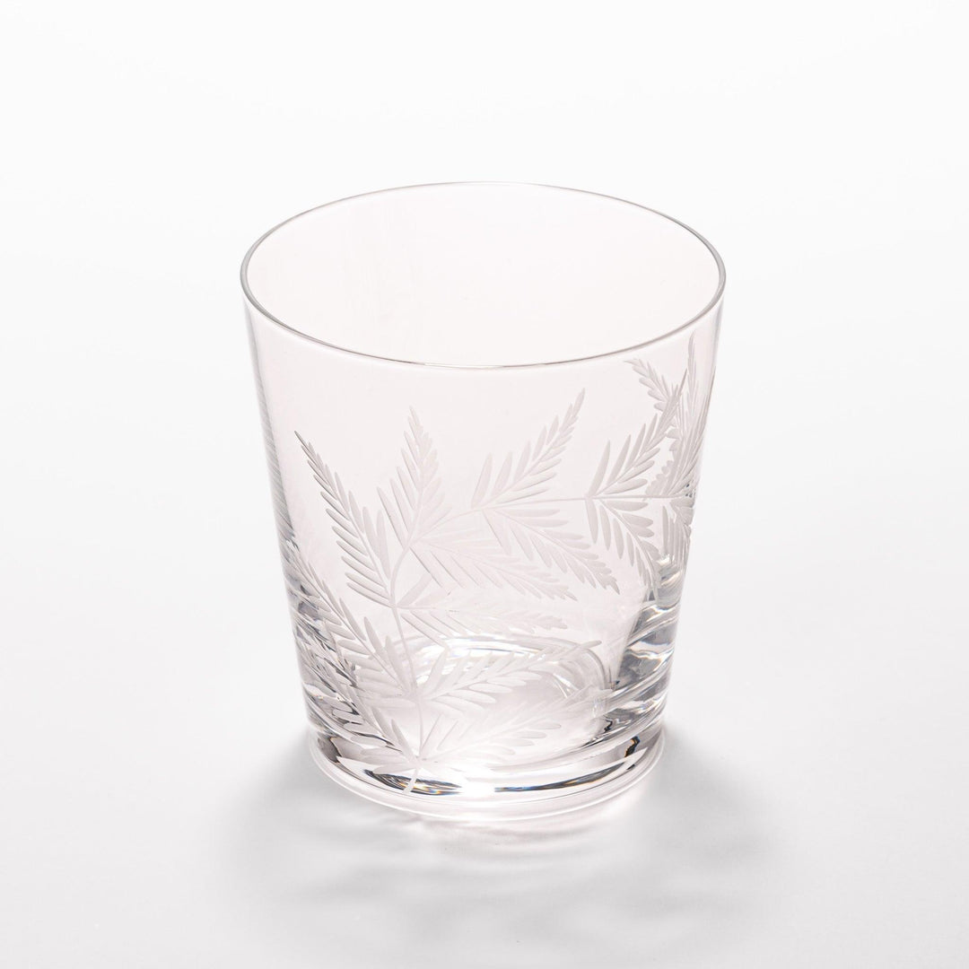 Elegant rocks glass with delicate fern engravings, offering a sophisticated design perfect for serving whiskey or other drinks.