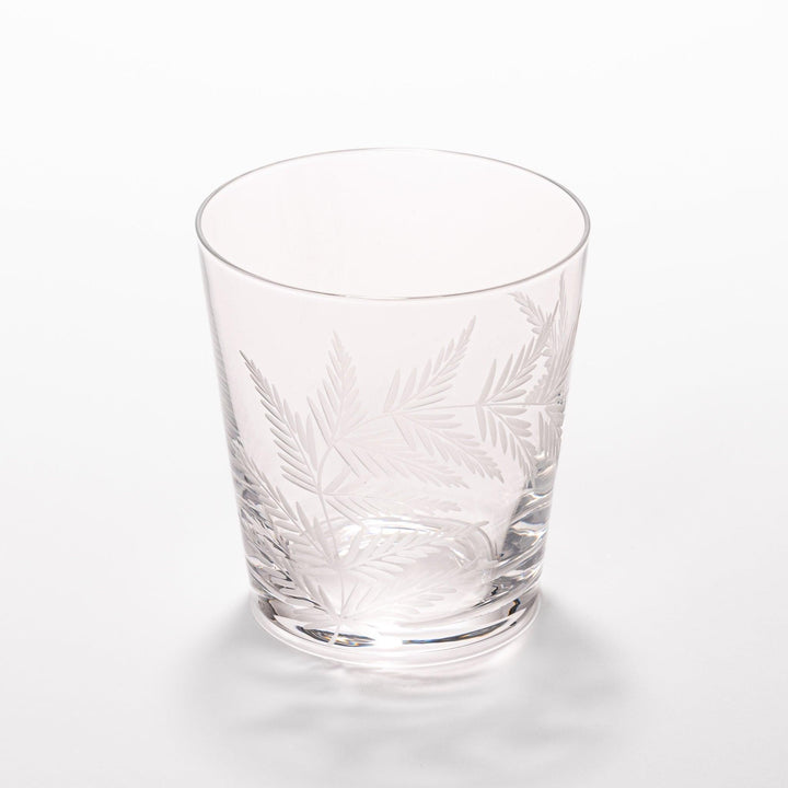 Elegant rocks glass with delicate fern engravings, offering a sophisticated design perfect for serving whiskey or other drinks.