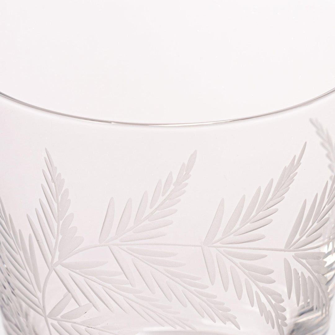 Elegant rocks glass with delicate fern engravings, offering a sophisticated design perfect for serving whiskey or other drinks.