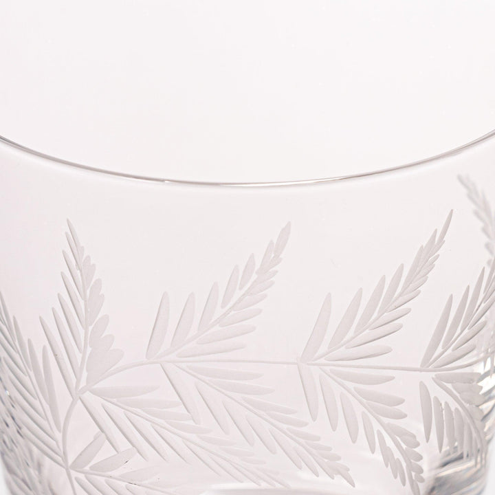 Elegant rocks glass with delicate fern engravings, offering a sophisticated design perfect for serving whiskey or other drinks.