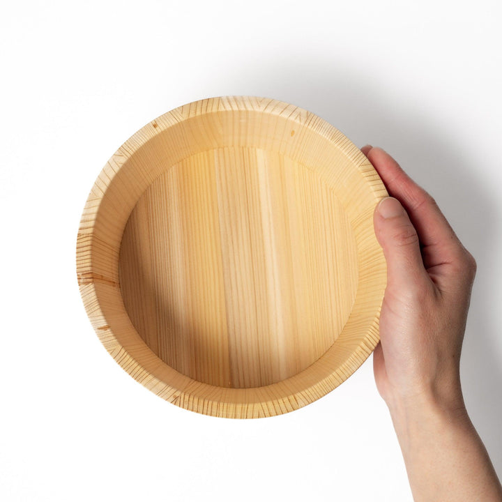 Wooden rice container with lid and paddle, made from natural wood with metal bands, ideal for storing and serving freshly cooked rice.