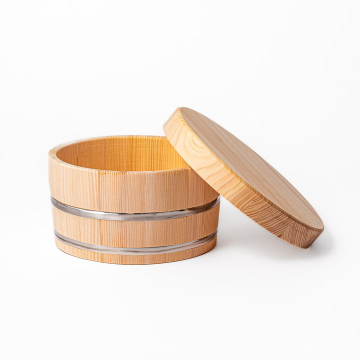 Wooden rice container with lid and paddle, made from natural wood with metal bands, ideal for storing and serving freshly cooked rice.