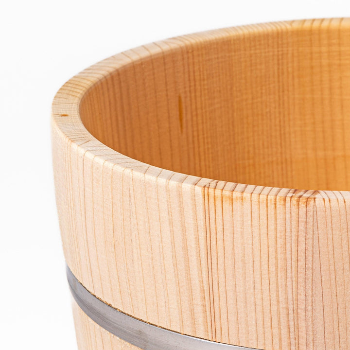 Wooden rice container with lid and paddle, made from natural wood with metal bands, ideal for storing and serving freshly cooked rice.