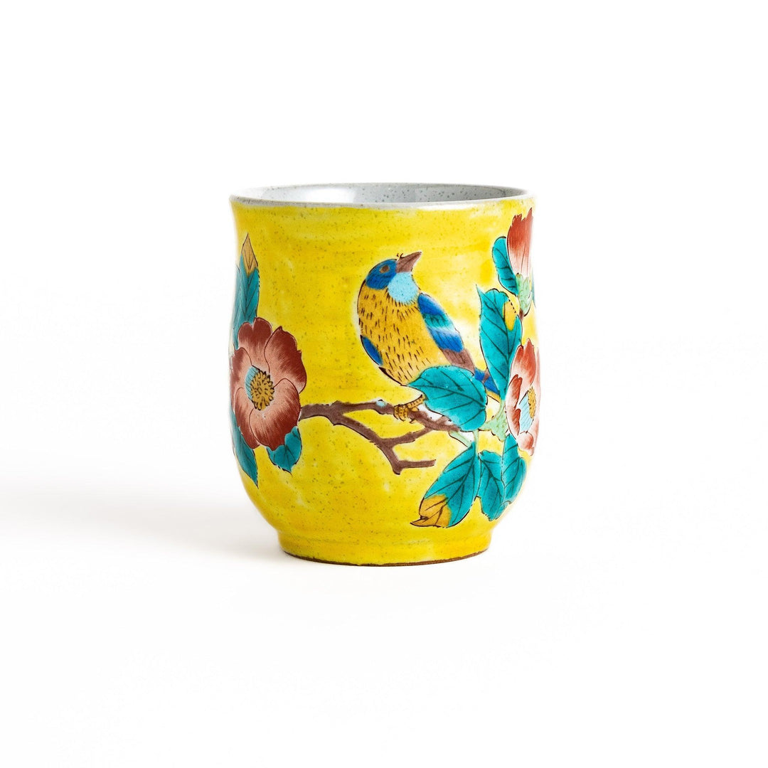 Yellow teacup with a colorful bird perched on a flowering branch, perfect for adding a touch of nature to your tea time.