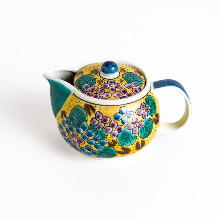 Vibrant yellow ceramic teapot with a colorful hydrangea pattern and a contrasting green spout. Perfect for adding a touch of cheer to your tea time.