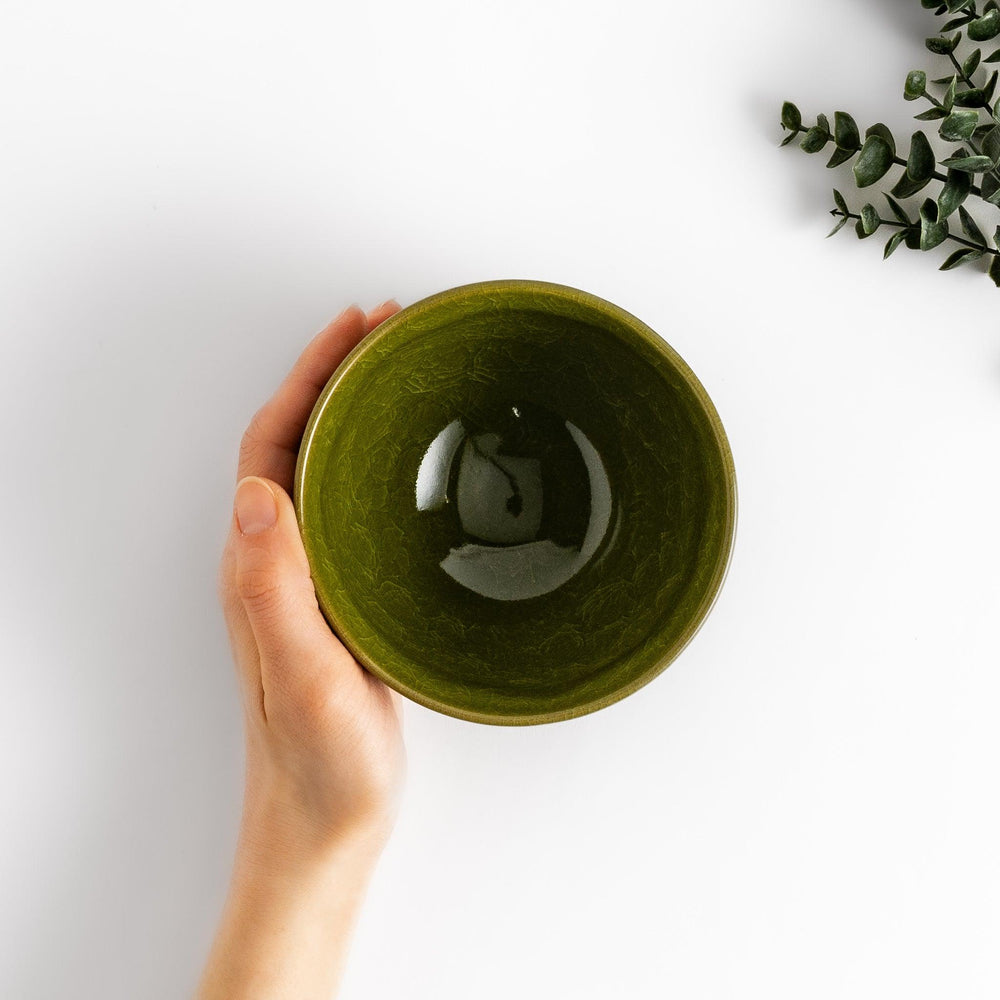 Artistic ceramic Matcha Bowl featuring a rich green glaze and a contrasting base.